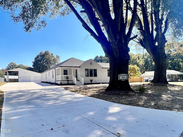 view of front of property featuring stucco siding, driveway, a porch, and a garage