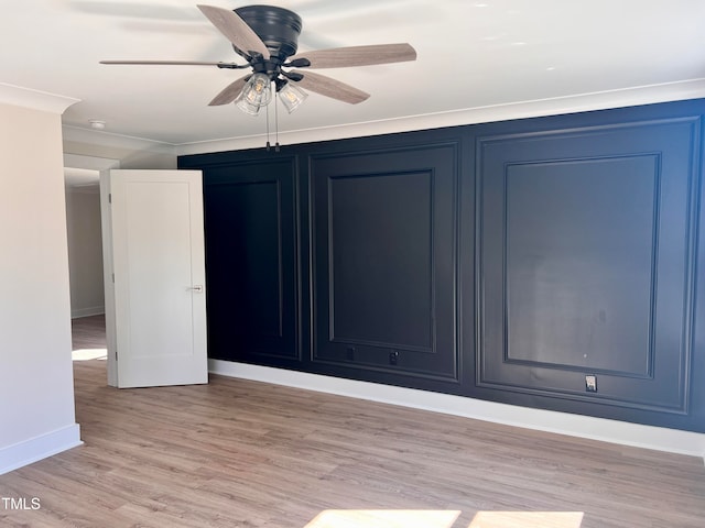 spare room with crown molding, ceiling fan, and light hardwood / wood-style floors