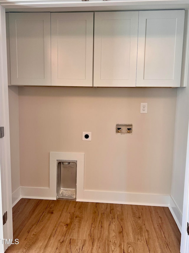 washroom with cabinets, hookup for a washing machine, light hardwood / wood-style floors, and hookup for an electric dryer