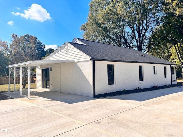 view of side of home featuring a carport