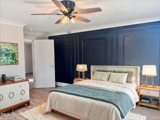 bedroom with ceiling fan, ornamental molding, and light wood-type flooring