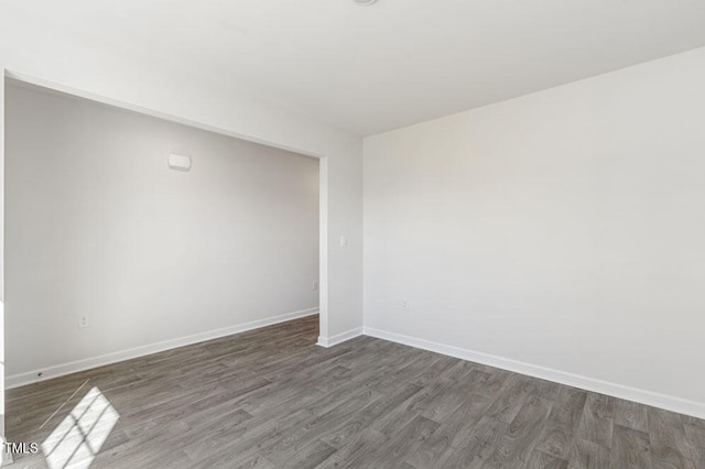 spare room with dark hardwood / wood-style flooring