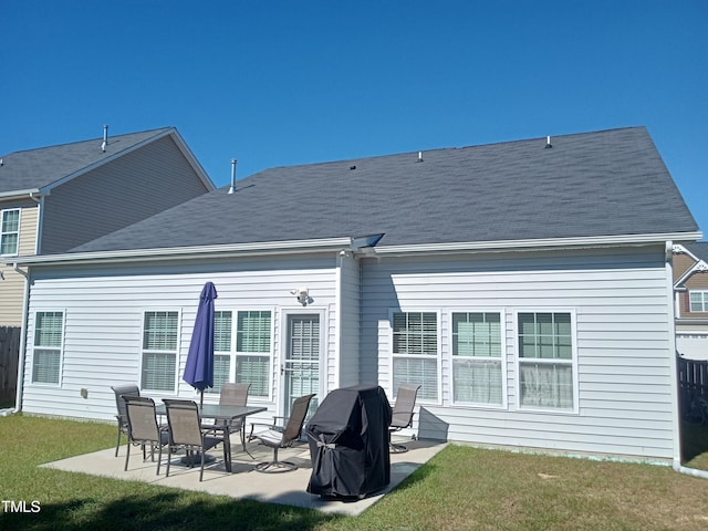 rear view of property with a patio area and a lawn