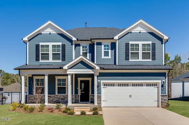 craftsman house with concrete driveway, a front lawn, stone siding, a porch, and a garage