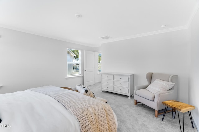 bedroom with baseboards, visible vents, light colored carpet, and ornamental molding