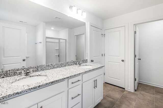 full bathroom featuring visible vents, a sink, and double vanity
