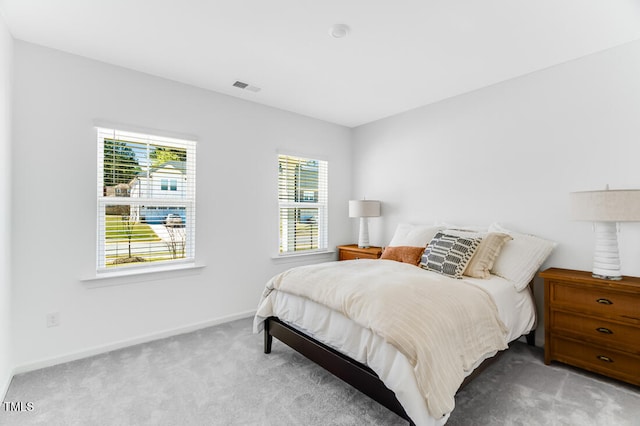 bedroom featuring carpet, visible vents, and baseboards