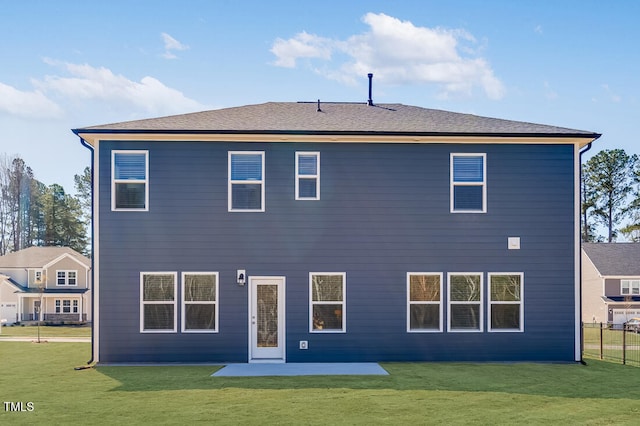 back of property with a lawn, a patio, and fence