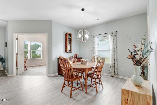 dining area featuring a chandelier and light hardwood / wood-style flooring