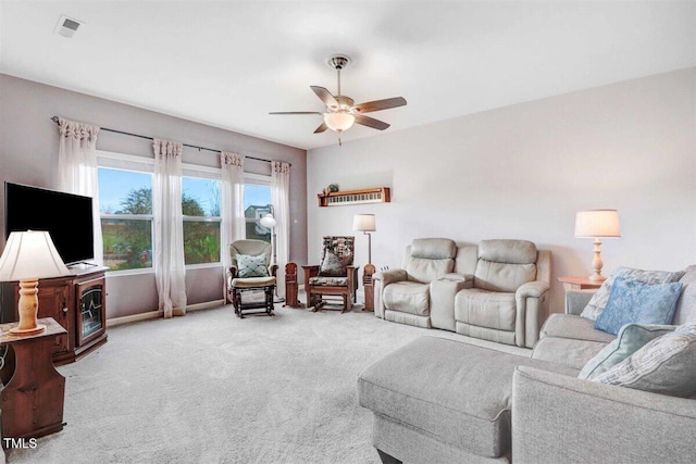 carpeted living room featuring ceiling fan