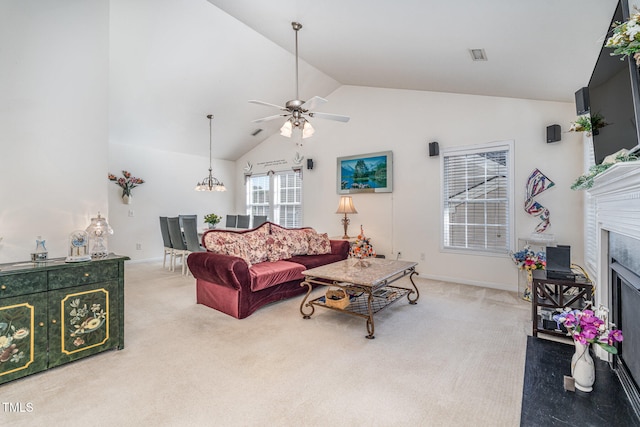 carpeted living room with vaulted ceiling and ceiling fan