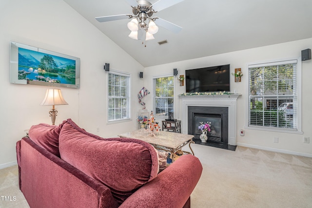 living room featuring ceiling fan, plenty of natural light, and light carpet