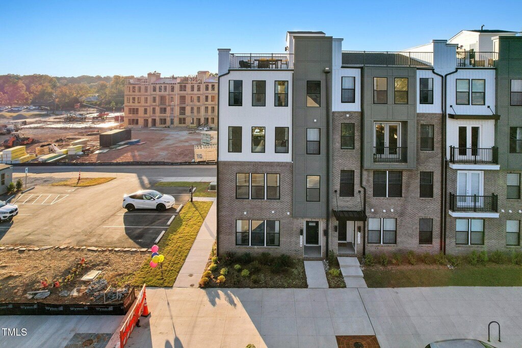 view of property featuring uncovered parking