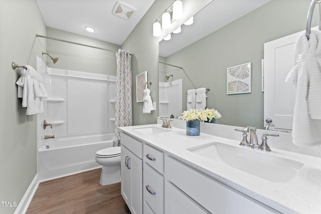 full bathroom with shower / bath combo with shower curtain, vanity, wood-type flooring, and toilet