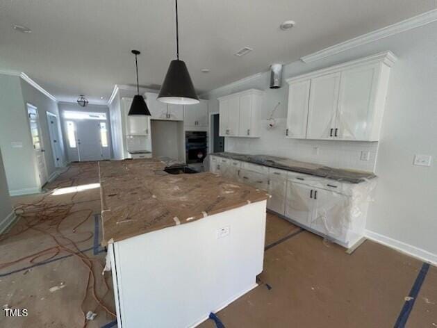 kitchen with pendant lighting, a kitchen island, and white cabinetry