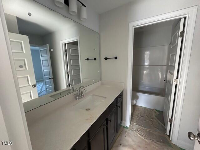 full bathroom featuring vanity, shower / bathtub combination, and toilet