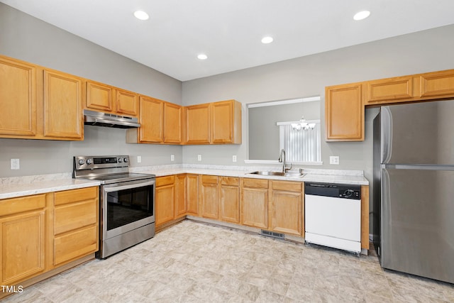 kitchen with hanging light fixtures, appliances with stainless steel finishes, and sink