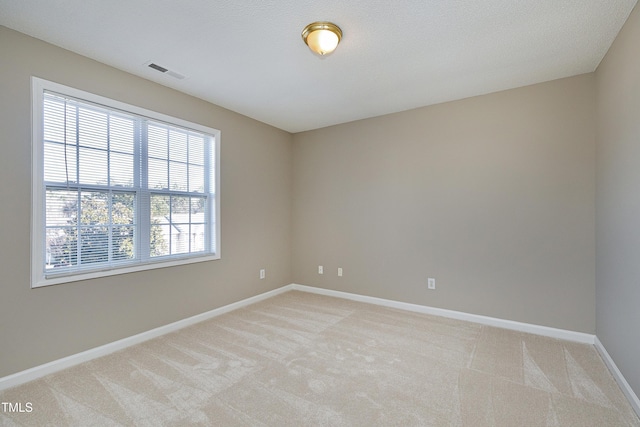 empty room featuring light carpet