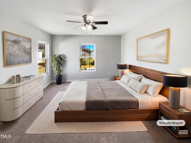 carpeted bedroom featuring ceiling fan and multiple windows