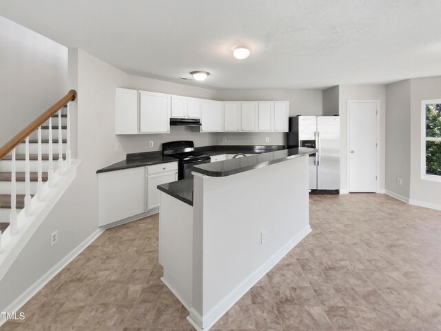 kitchen with white cabinets, stainless steel refrigerator with ice dispenser, and black range