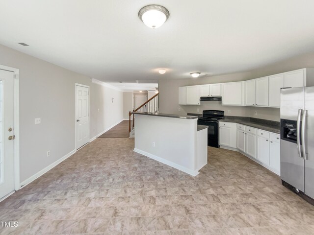 kitchen featuring black electric range, white cabinets, a center island, and stainless steel fridge