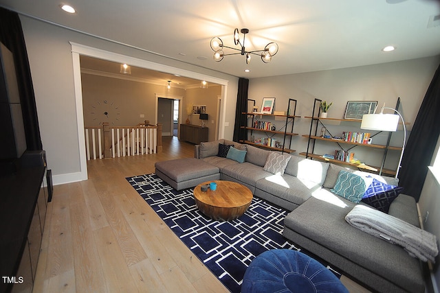 living room with ornamental molding, a chandelier, and hardwood / wood-style floors