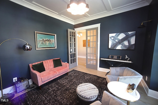 living room featuring french doors, hardwood / wood-style floors, coffered ceiling, and crown molding