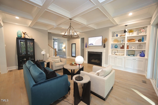 living room featuring light hardwood / wood-style flooring, beam ceiling, a notable chandelier, and coffered ceiling