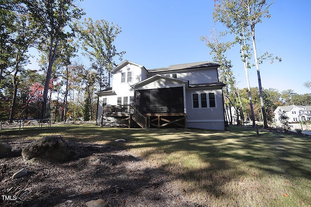 rear view of property featuring a yard and a sunroom