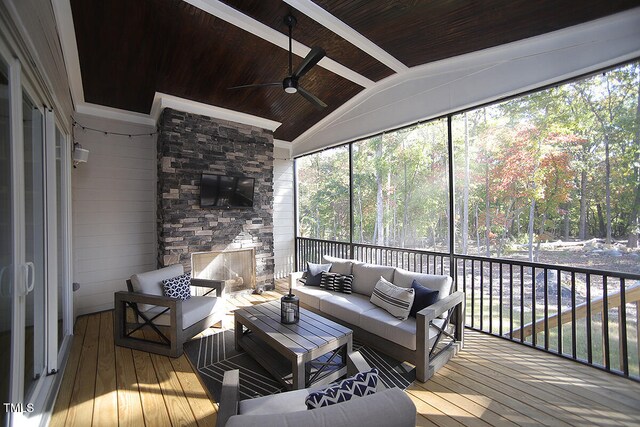 sunroom / solarium featuring lofted ceiling with beams, wood ceiling, and ceiling fan