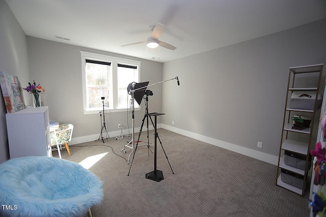 workout area featuring ceiling fan and carpet floors