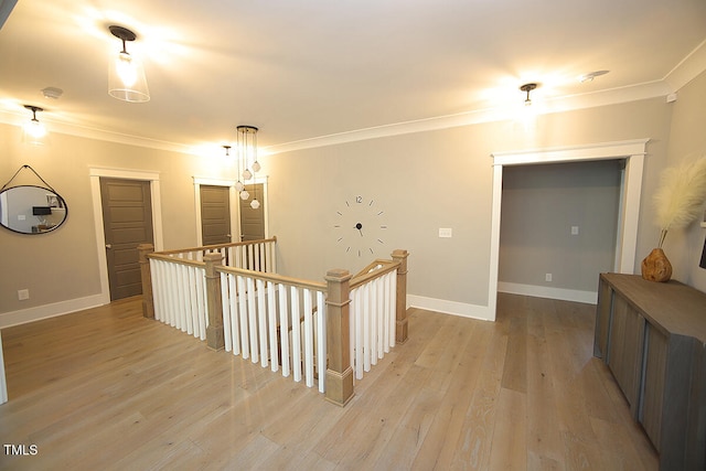 hallway with ornamental molding and light wood-type flooring