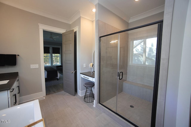 bathroom with vanity, an enclosed shower, ornamental molding, and plenty of natural light