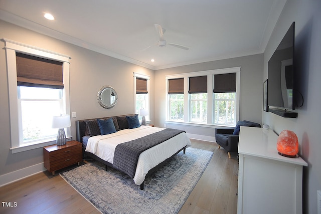 bedroom featuring crown molding, light wood-type flooring, and ceiling fan