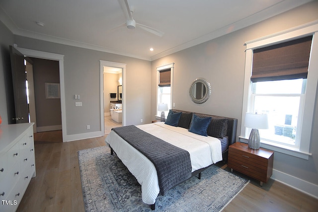 bedroom with ensuite bath, ornamental molding, light wood-type flooring, and ceiling fan