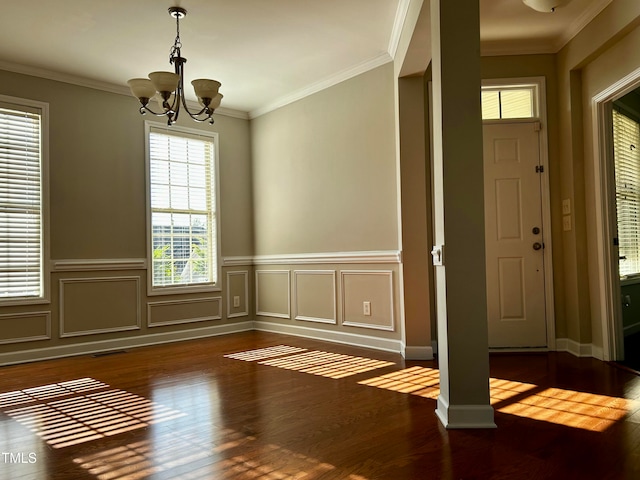 entrance foyer featuring crown molding, an inviting chandelier, and dark hardwood / wood-style flooring