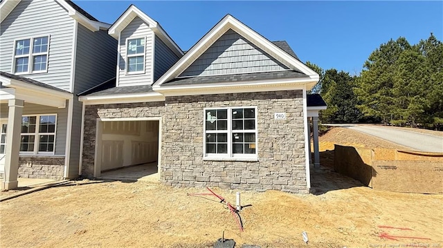 view of front of home with a garage and dirt driveway