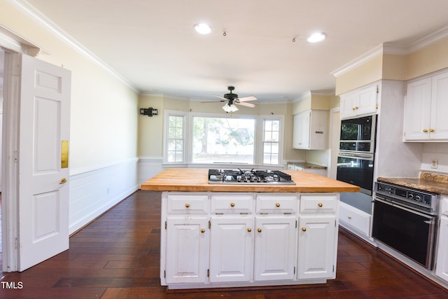 kitchen featuring black appliances, butcher block countertops, dark hardwood / wood-style floors, and white cabinets