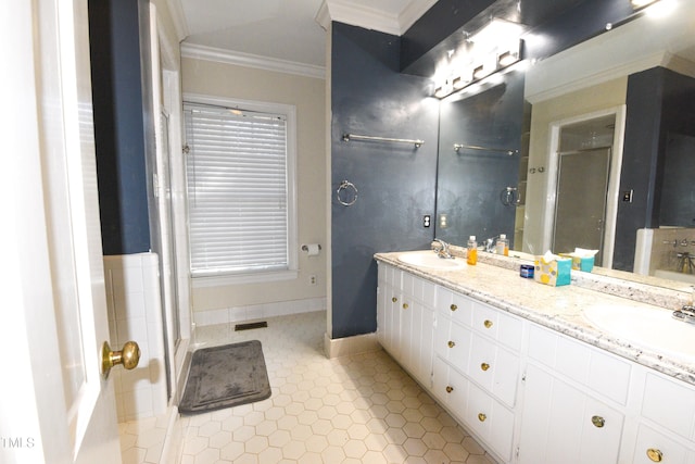 bathroom featuring vanity, crown molding, and a shower with shower door