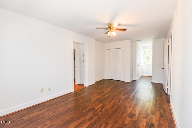 empty room featuring ceiling fan and dark hardwood / wood-style flooring