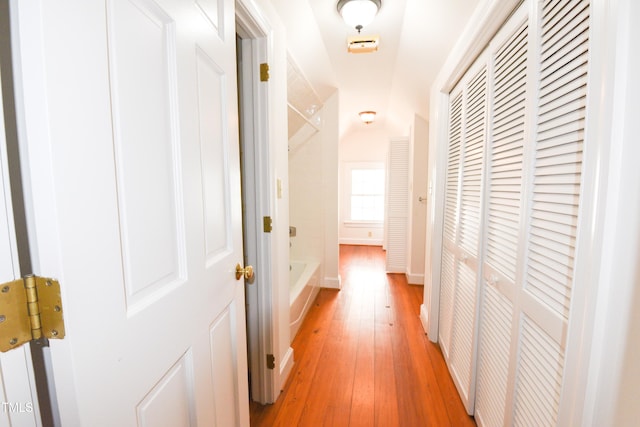 hallway with hardwood / wood-style floors