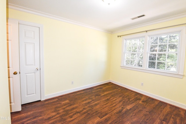 empty room featuring crown molding and dark hardwood / wood-style flooring