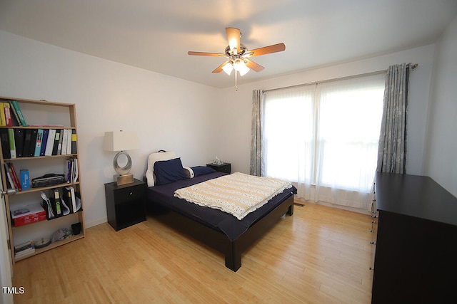 bedroom with light hardwood / wood-style flooring, multiple windows, and ceiling fan