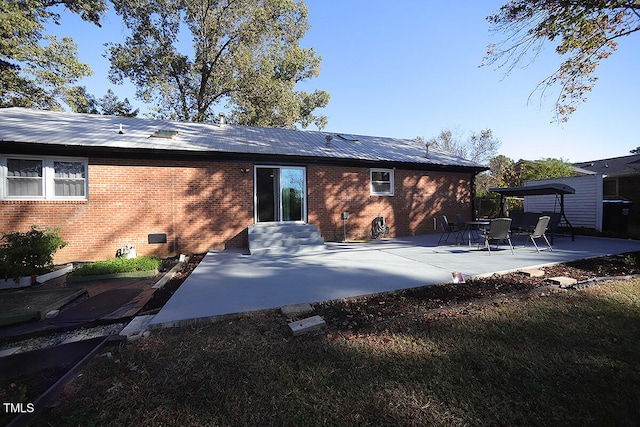 back of property featuring a patio