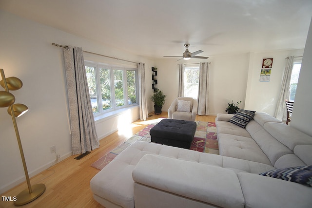 living room featuring ceiling fan and light hardwood / wood-style flooring