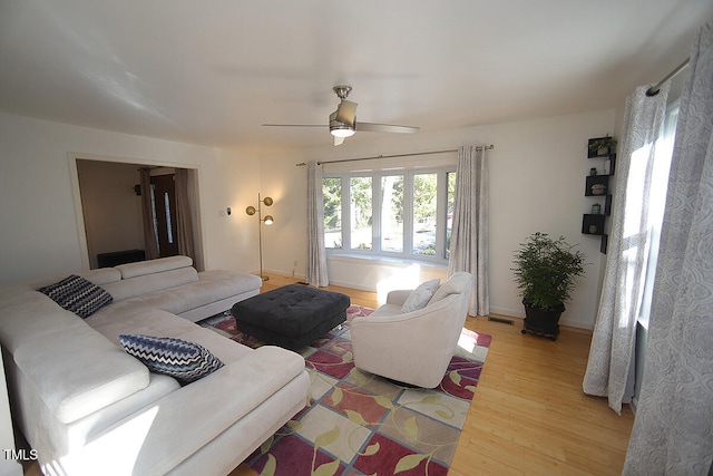 living room featuring hardwood / wood-style floors and ceiling fan