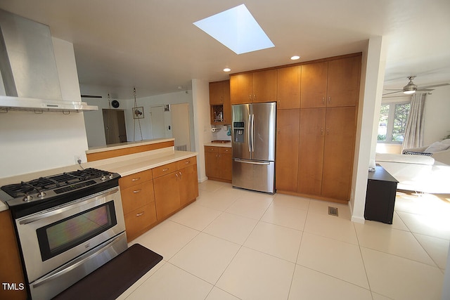 kitchen featuring ceiling fan, stainless steel appliances, light tile patterned floors, and range hood