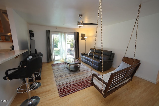 living room featuring hardwood / wood-style floors and ceiling fan