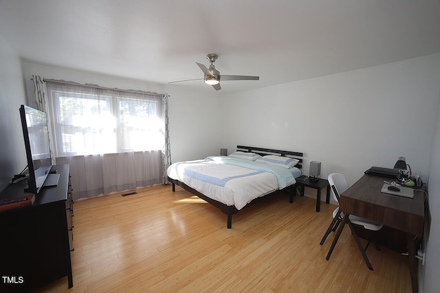 bedroom with light wood-type flooring and ceiling fan