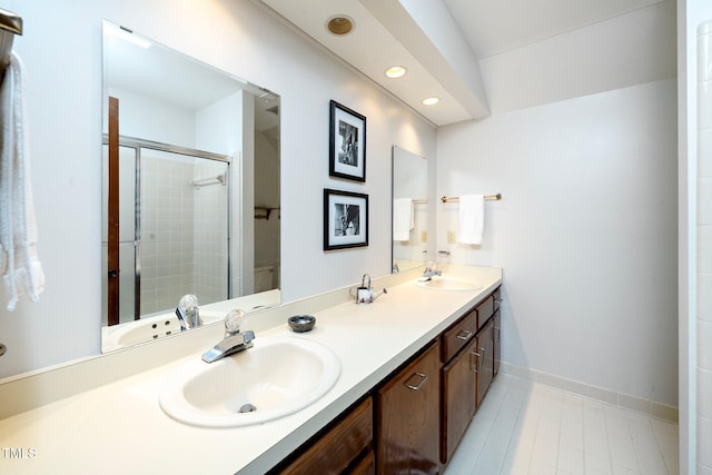 bathroom with tile patterned flooring, vanity, and an enclosed shower